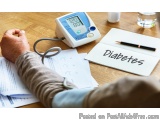 The image shows a person's hand holding a blood pressure monitor with a cuff. The monitor is white with a blue display and a...
