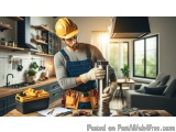 In this image, we can see a man wearing a yellow hard hat and overalls, working in a kitchen. He is standing in front of a ki...