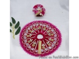 The image shows a pink circular brooch with intricate gold and silver embroidery. The brooch is made of a pink fabric with a...