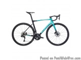 The image is of a blue and black bicycle. The bike has a sleek design with a black frame and handlebars. The saddle is black...