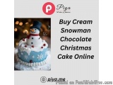 The image is an advertisement for a Christmas cake online. It features a photo of a snowman cake with a blue base and white f...