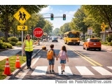 The image shows a busy street scene with a stop sign and a pedestrian crossing. There are three children crossing the street,...