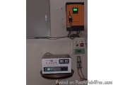 The image shows an electrical panel with an orange-colored control panel and a white-colored device with the word "Lazer" wri...