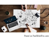 The image shows a desk with a laptop, a camera, a plant, and other office supplies scattered around. On the desk, there is a...