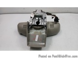 The image shows a small electronic device, which appears to be a part of a vehicle's door lock mechanism. It is made of metal...