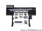 The image shows a large format printer, specifically a Mimaki CVS-100-2, which is a type of printing machine. The printer is...