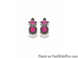 The image shows a pair of earrings. The earrings are made of silver and have a teardrop shape. The top of the earrings have a...