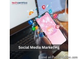 The image shows a person's hand holding a smartphone with various social media icons coming out of it. The phone screen displ...