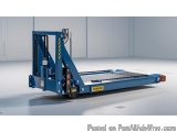 The image shows a blue-colored industrial machine with a yellow and black striped handle. It appears to be a hydraulic liftin...