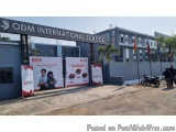 The image shows the entrance of ODM International School. The entrance is marked by a large arch with the school's logo on it...