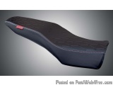The image shows a black motorcycle seat with a unique design. The seat is made of a soft, plush material and has a textured s...