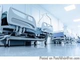 The image shows a row of hospital beds in a hospital room. The beds are made of metal and have a modern design with a curved...