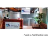 The image shows the reception area of a modern office with a wooden reception desk and a brown sofa. On the desk, there is a...