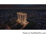 The image is an aerial view of a tall, modern building at night. The building appears to be a high-rise, with multiple floors...