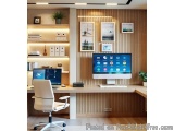 The image shows a modern home office with a wooden desk and a computer monitor. The desk is made of light-colored wood and ha...
