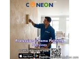 The image shows a man painting a wall with a paint roller. He is wearing a blue uniform with the logo of Conneon, a company t...