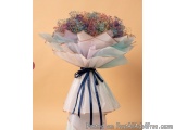 The image is of a beautiful bouquet of flowers. The bouquet is made up of a variety of colorful flowers, including small purp...
