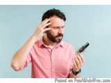 The image shows a man with a beard and mustache, wearing a pink collared shirt. He is holding a black hair straightener in hi...