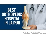 The image shows a doctor holding a model of the knee joint in his hand. The model is made of a light-colored material and is...