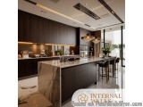 The image is of a modern kitchen with a large island in the center. The island has a marble countertop and is surrounded by d...