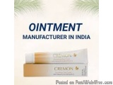 The image is an advertisement for Ointment Manufacturer in India. It has a white background with a green palm tree branch des...