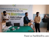 The image shows three men standing in front of a table with a banner that reads "Chitravansham Group of College (Knowledge Br...