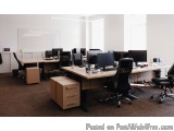The image shows an empty office space with multiple computer desks and chairs. The desks are arranged in a neat and organized...