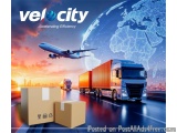 The image is an advertisement for Velocity, an international logistics company. The background of the image is a cityscape wi...