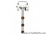 The image shows a white-colored machine with three wheels attached to it. The machine appears to be a medical device, possibl...