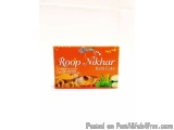 The image is of a box of Roop Nikhar Bath Cake. The box is rectangular in shape and has an orange background with white text....