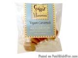 The image is of a packaged sugar mamma vegan caramels. The packaging is a transparent plastic bag with a blue and yellow labe...