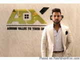 The image shows a young man standing in front of a wall with the logo of AX Group. The logo is a combination of the letters "...