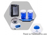 The image shows a laboratory equipment set up on a gray background. On the left side of the image, there is a black electroni...