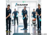 The image shows a group of five people, four women and one man, cleaning the floor in a clean and well-maintained room. They...