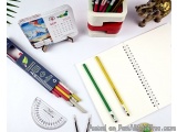 The image shows a desk with various stationery items scattered on it. On the left side of the image, there is a calendar with...