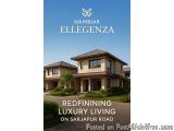 The image is a photograph of a luxurious two-story house named Namibiar Ellegenza. The house is located on Sarajapur Road in...