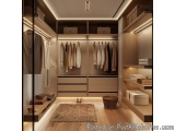 The image shows a modern and luxurious walk-in closet with wooden shelves and drawers. The closet has a large wooden wardrobe...