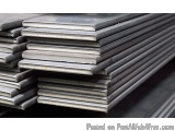 The image shows a stack of metal sheets. The sheets are arranged in a horizontal manner and appear to be made of steel or alu...