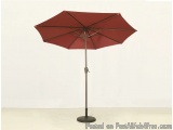 The image shows a red umbrella with a black base. The umbrella is open and has a curved shape with a pointed top. The base is...