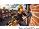 The image shows a young woman wearing a yellow hard hat and blue gloves, working on a brick wall. She is wearing a black swea...