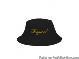 The image is of a black bucket hat with the word "Rejoice!" written in gold cursive font in the center. The hat appears to be...