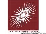 The image is a square logo for the Dean Foundation. The logo is a red square with a white starburst design in the center. The...