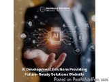 The image shows a man in a suit holding a small electronic device with the word "AI" on it. The device appears to be a circui...
