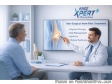 The image shows a doctor and a patient sitting at a desk in a medical office. The doctor is wearing a white coat and a stetho...