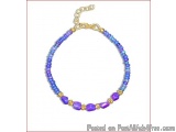 The image is of a beaded bracelet. The bracelet is made up of small, round beads in shades of blue, purple, and gold. The bea...