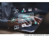 The image shows a person's hands typing on a laptop with the words "Digital Marketing" on the screen. The laptop is placed on...