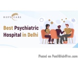 The image is an advertisement for Hope Care, a best psychiatric hospital in Delhi. It features a group of four people sitting...