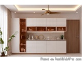 The image shows a modern kitchen with a minimalist design. The kitchen has a white countertop with a sink and a built-in shel...