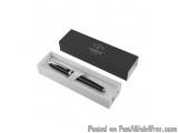 The image shows a black box with a silver pen inside. The box is rectangular in shape and has a flat top. The pen has a sleek...