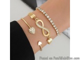 The image shows a close-up of a person's wrist wearing multiple bracelets. The bracelets are made of gold and are arranged in...
